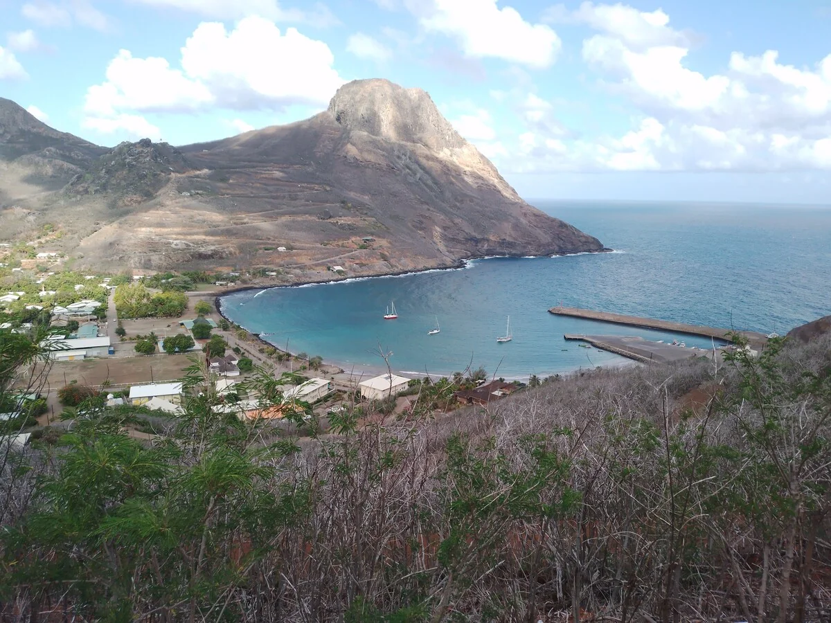 Hakahau Bay from above, with the village, the harbour and sailing boats at anchor