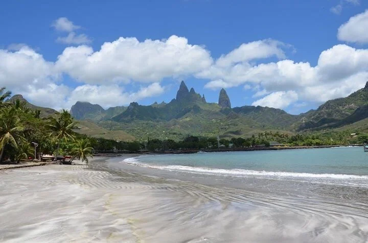 Hakahau's sandy beach, with Ua Pou's volcanic peaks in the background